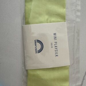One Sarah’s Silks mini play silk. Lime green